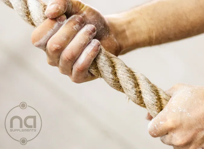 image of man tightly gripping rope