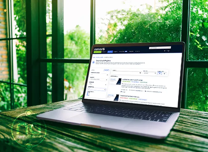 laptop on wooden table with na supplements logo