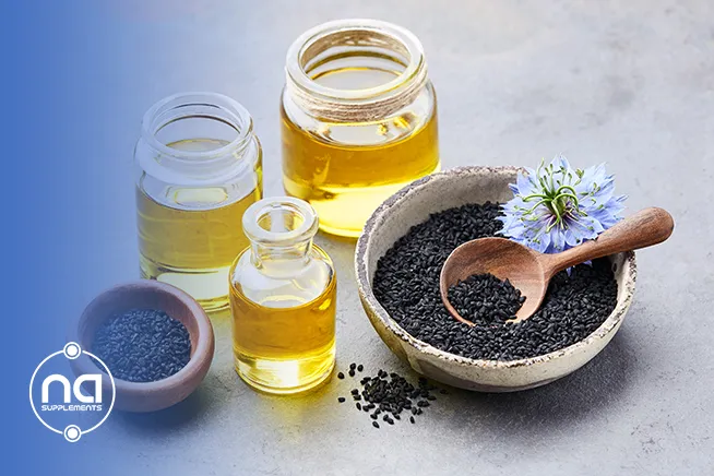 black seeds in a plate beside bottles of oil on black seed oil for anxiety blog