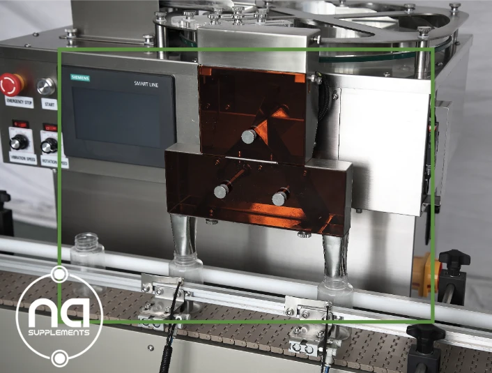close up of twin discharge chute dispensing mechanism on our fully automatic pill counting machine na supplements