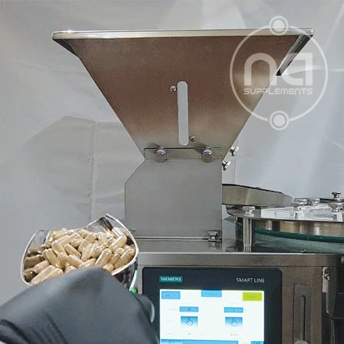 na supplement technician loading pill counting machine with capsules