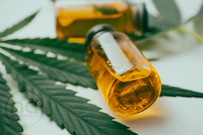 cbd oil in vials next to green leaves
